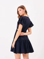 Female model wearing a navy blue dress from Stylera, showcasing backside
