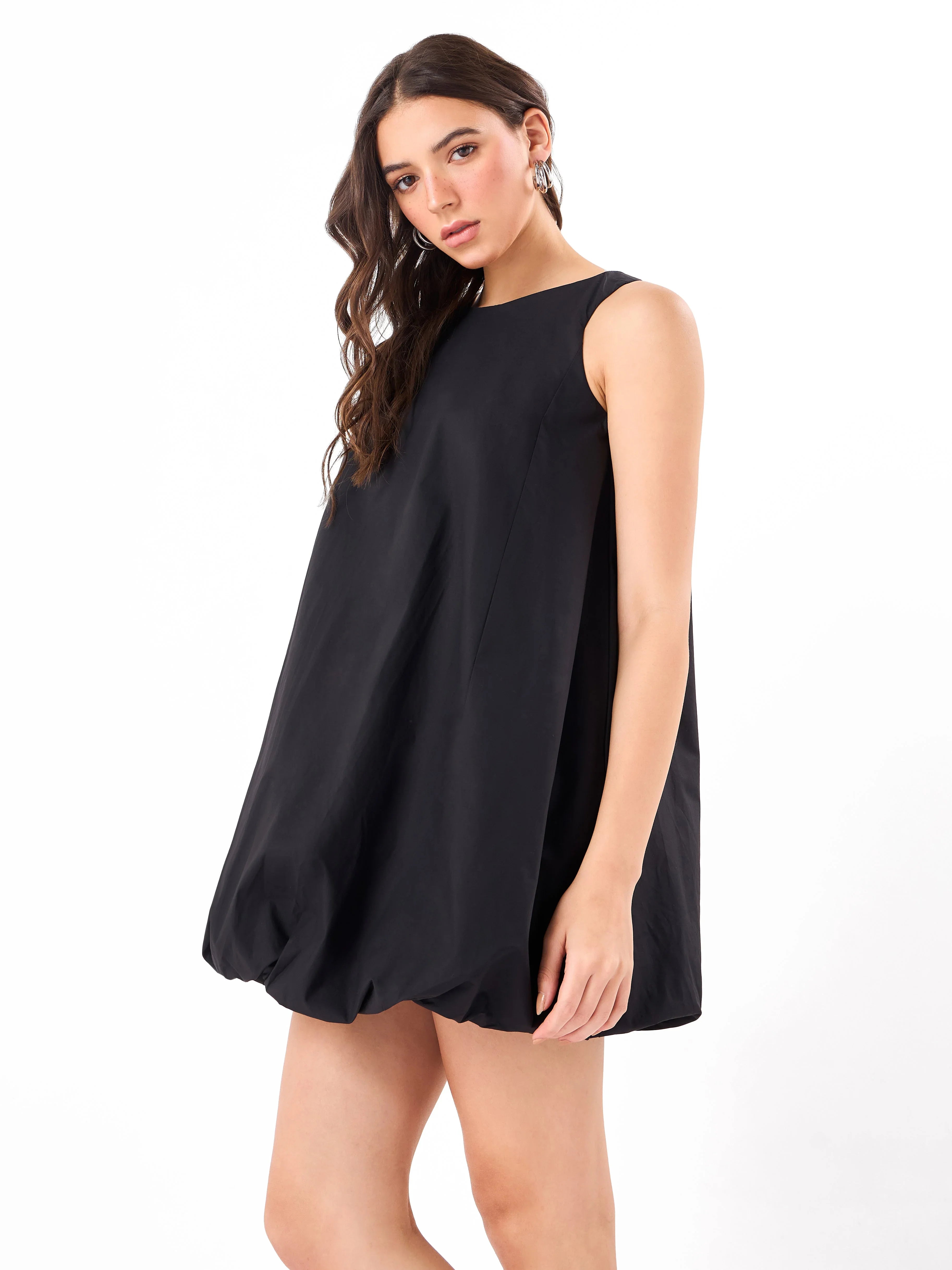 Female model wearing a black sleeveless mini dress from Stylera