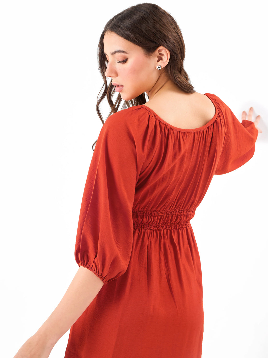 Female model wearing a red shirring dress from Stylera