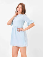 Female model wearing a light blue dress from Stylera