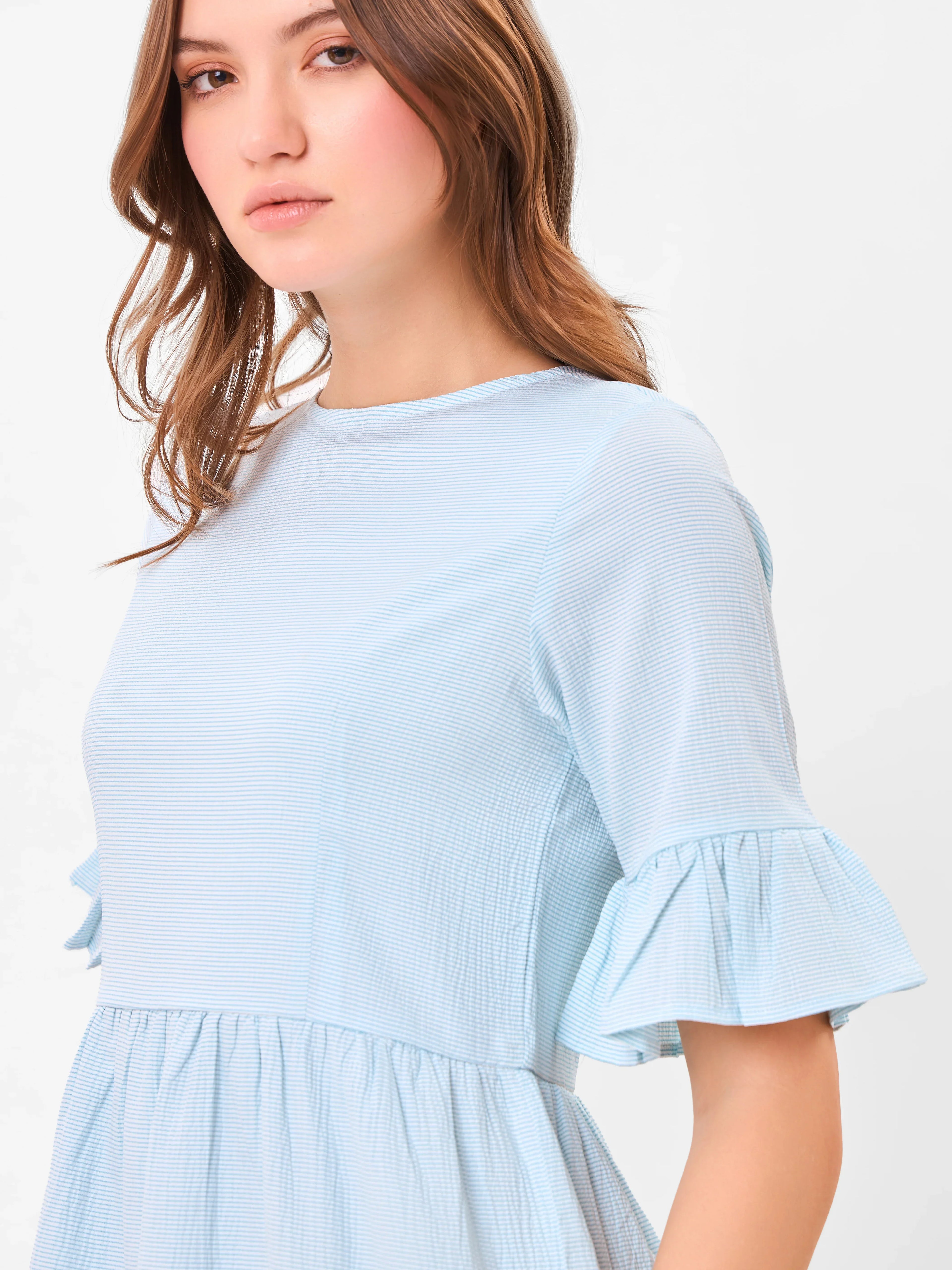 Female model wearing a light blue dress with half sleeves from Stylera