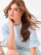 Female model wearing a round neck light blue dress from Stylera