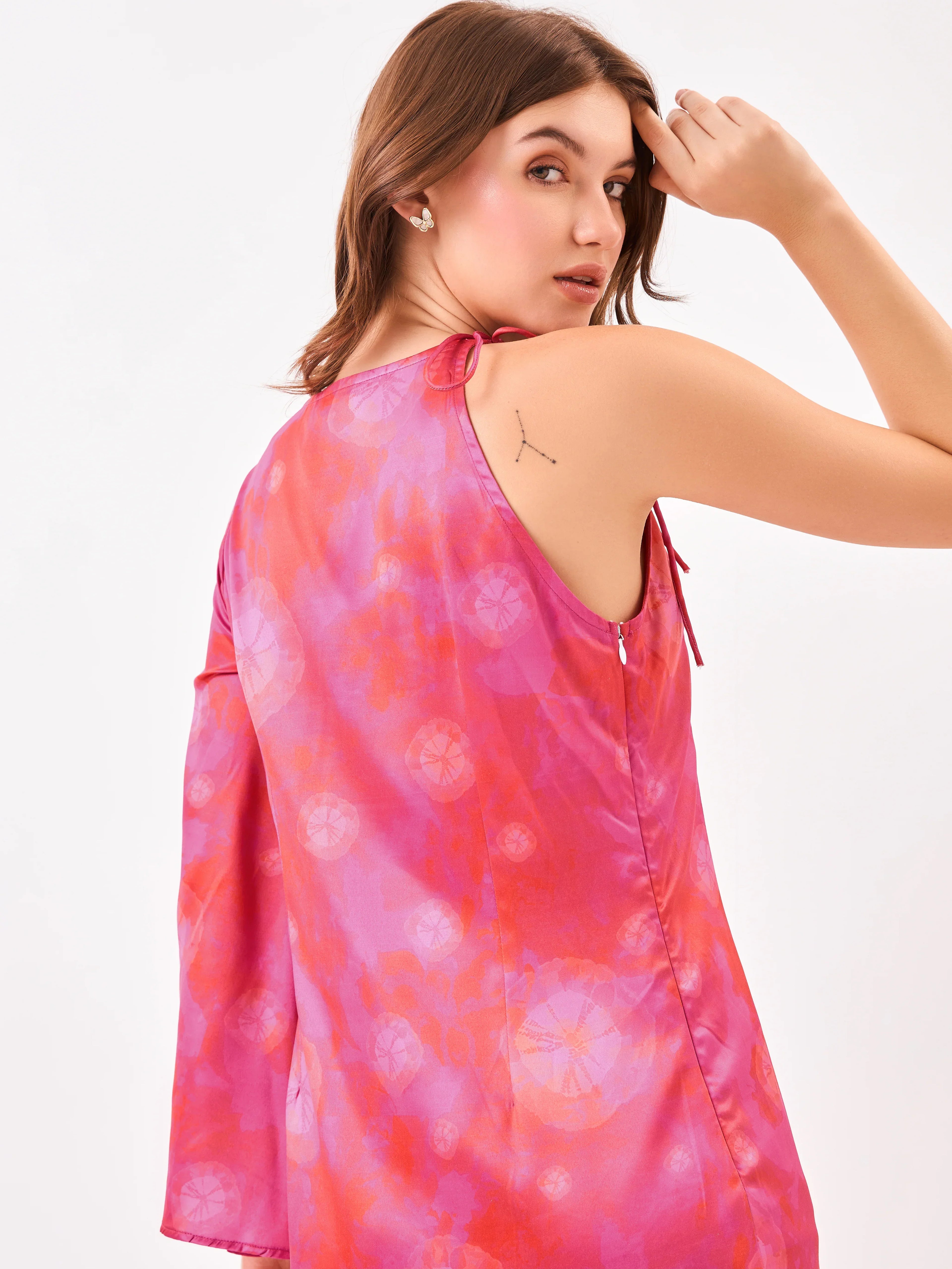 Female model wearing a pink tie-dye dress with side zip from Stylera