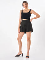 Female model wearing a black shorts from Stylera, styling with black tank top
