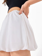 Female model wearing a white polyester mini skirt  from Stylera