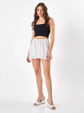Female model wearing a white mini skirt  from Stylera