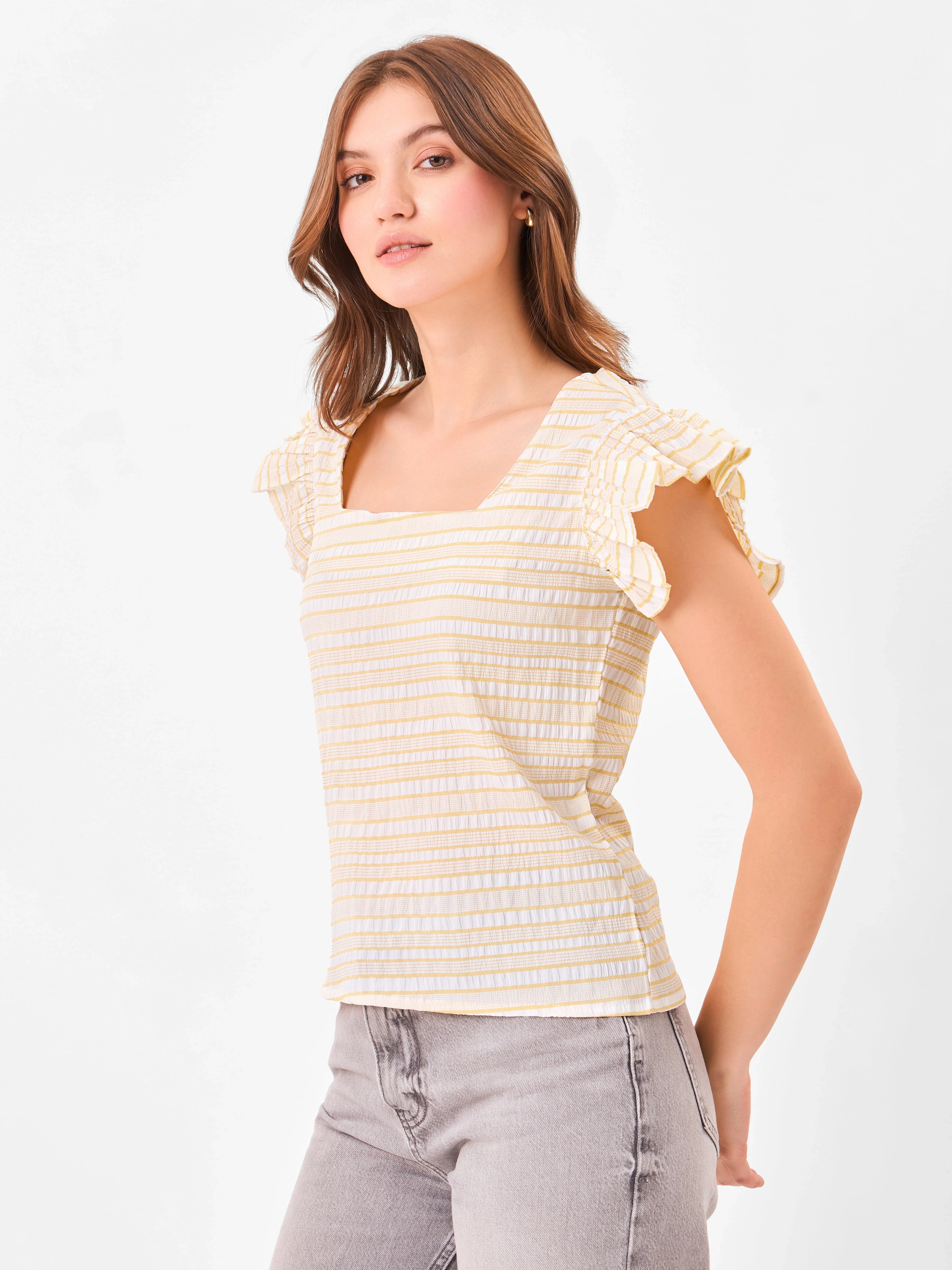 Female model wearing a yellow and white striped top with ruffled sleeves from Stylera