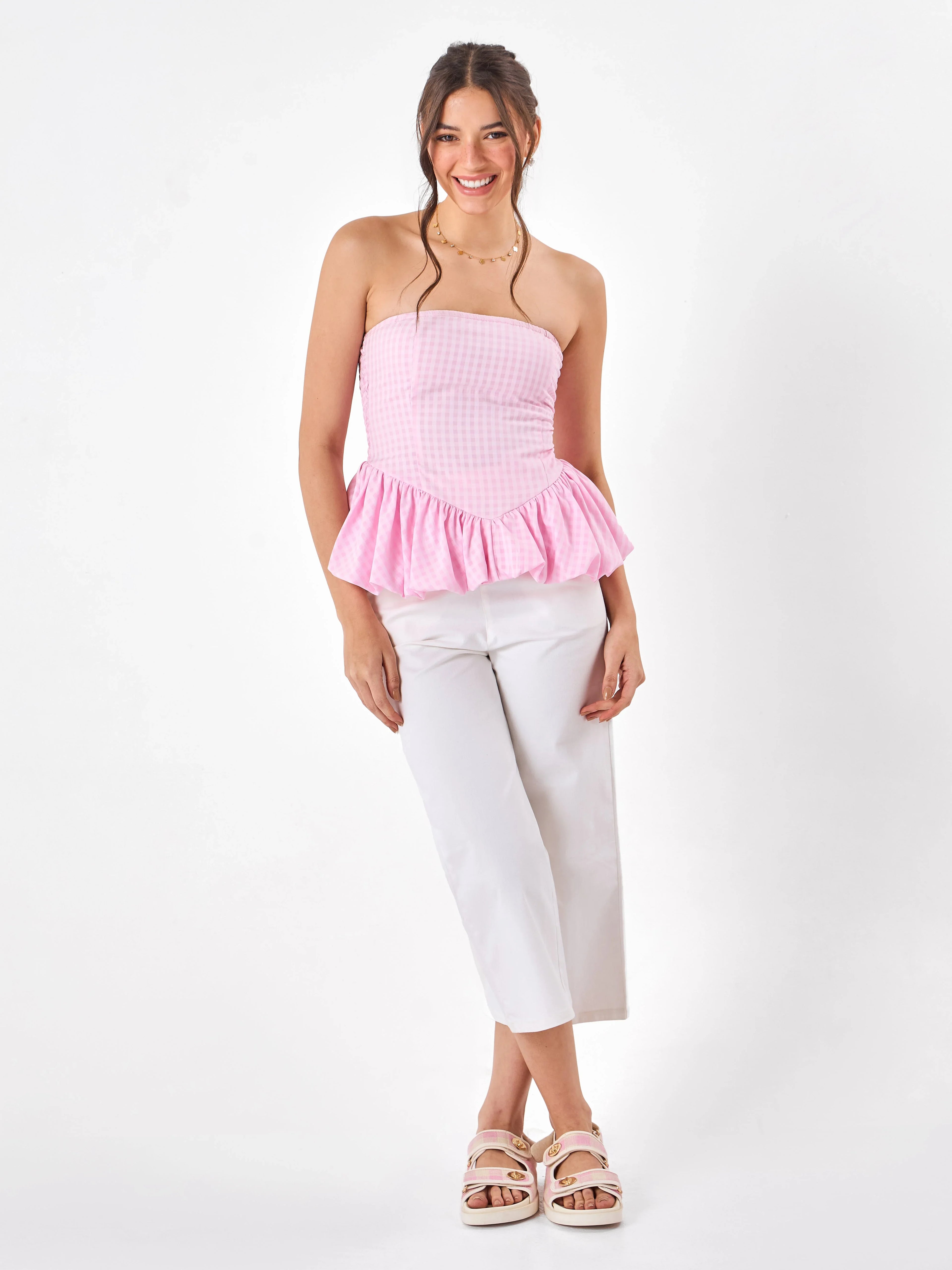 Female model wearing a pink top from Stylera