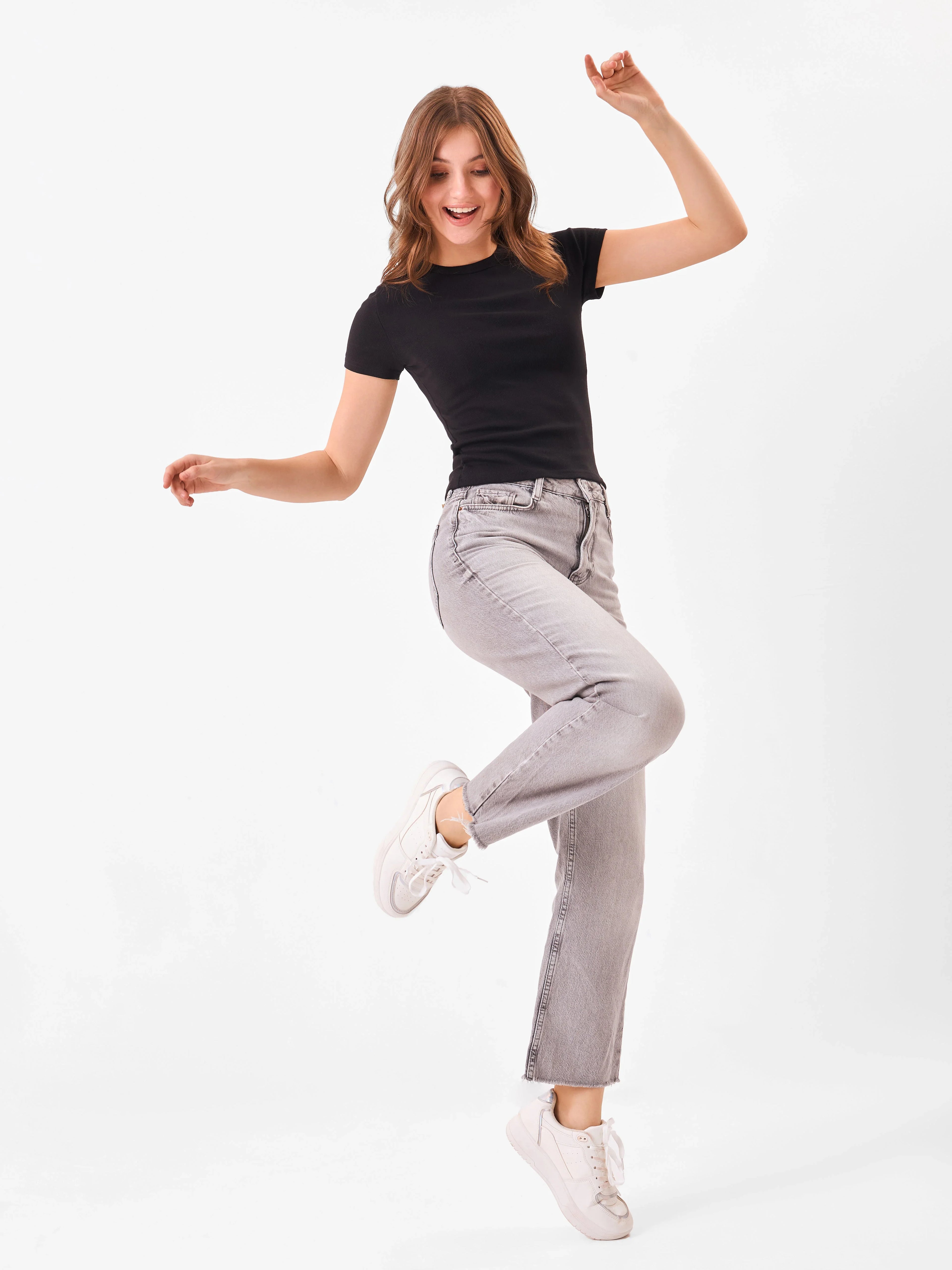 Female Model wearing a black t-shirt from Stylera, pairing with grey denim