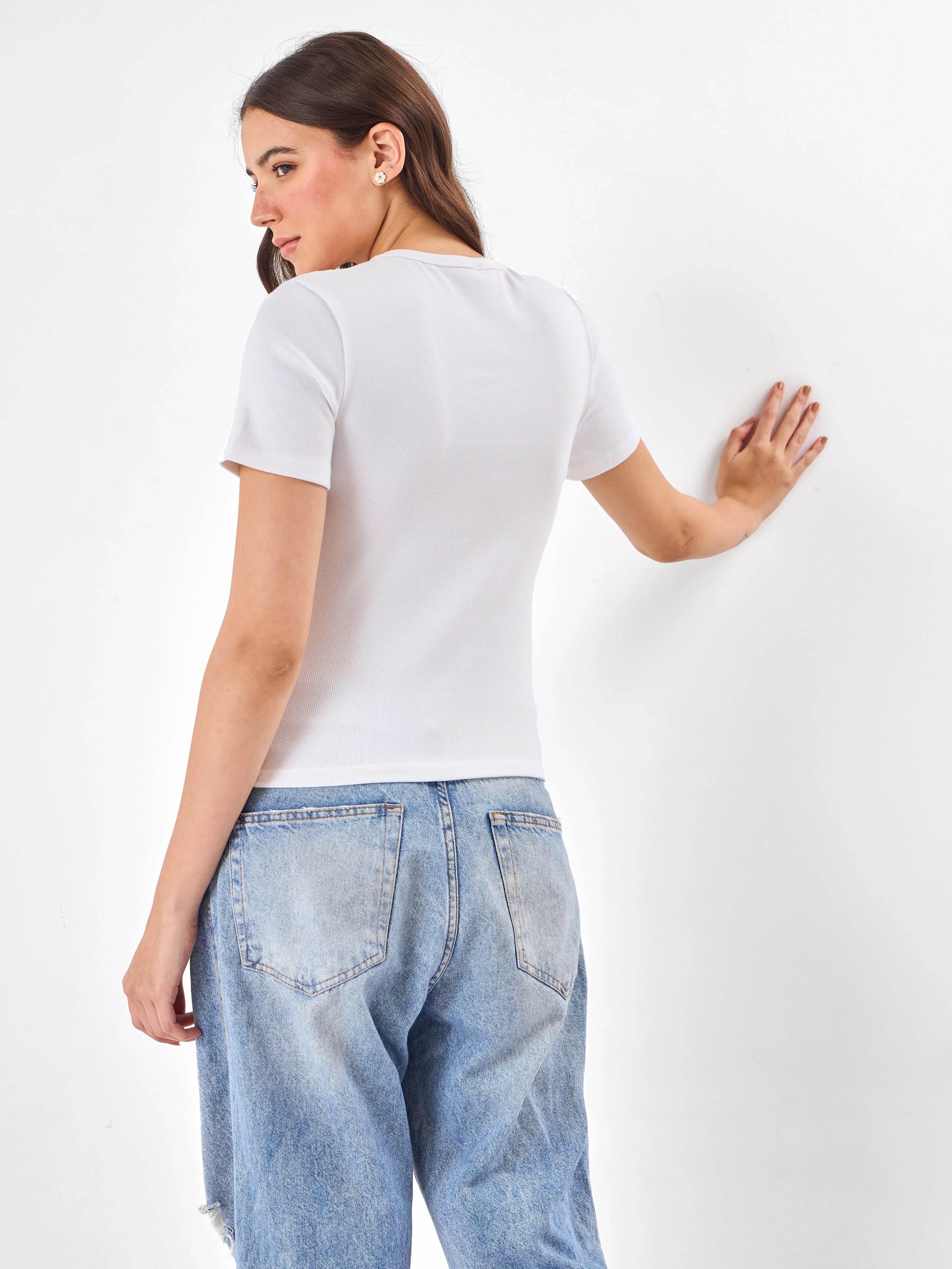 Female Model wearing white top from Stylera, showcasing backside