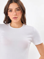 Female Model wearing round neck white top from Stylera