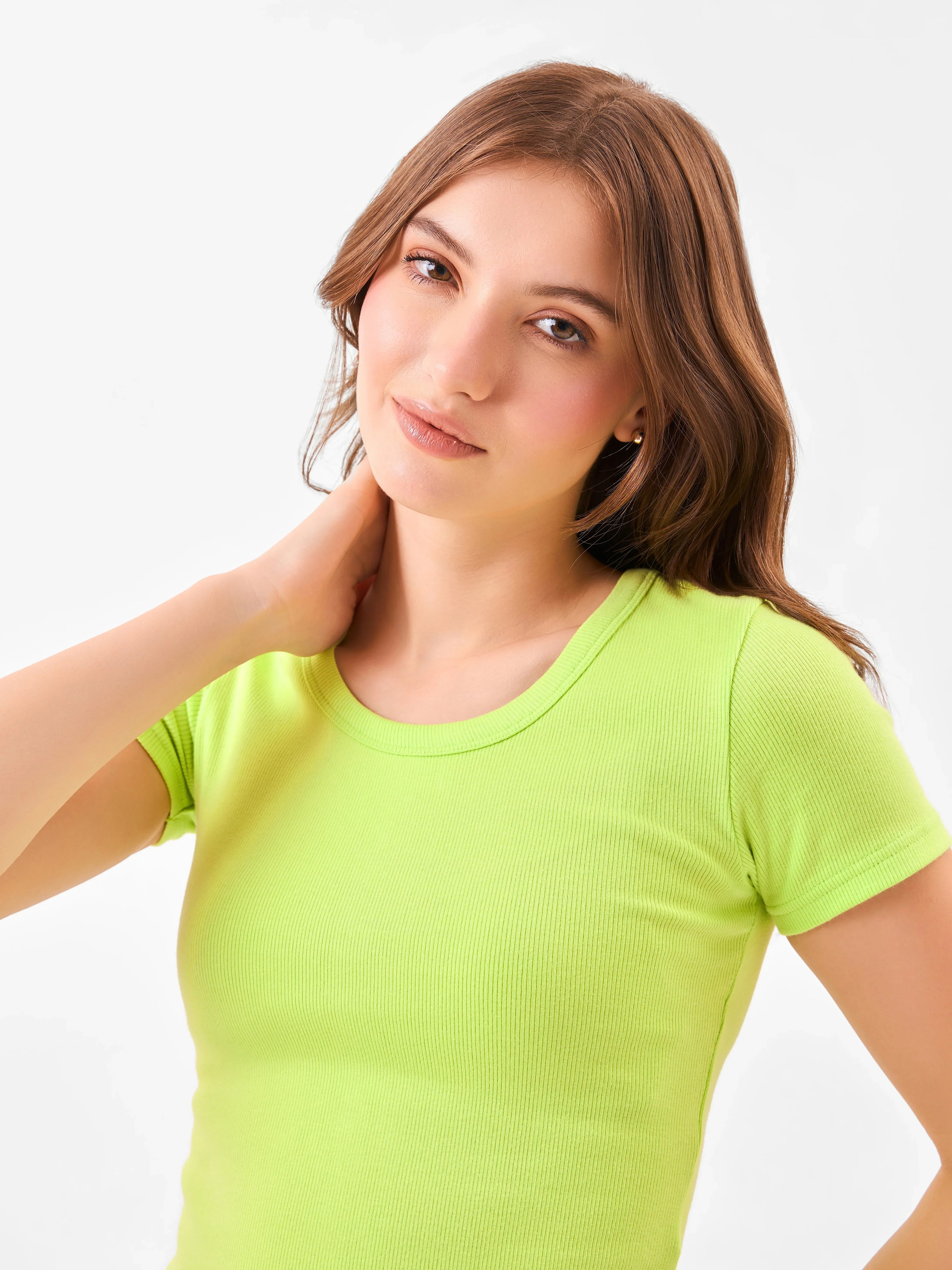 Female model wearing a bright green t-shirt from Stylera
