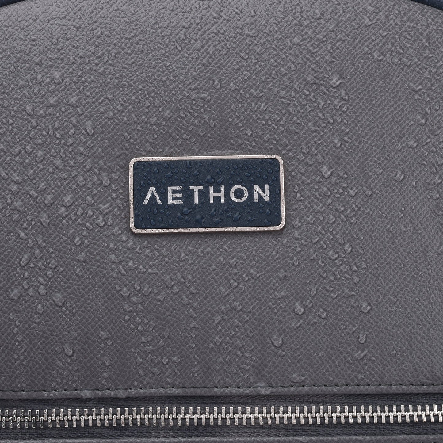 Stylera brand logo on gray water resistant backpack with droplets and zipper Apex Backpack for work and travel