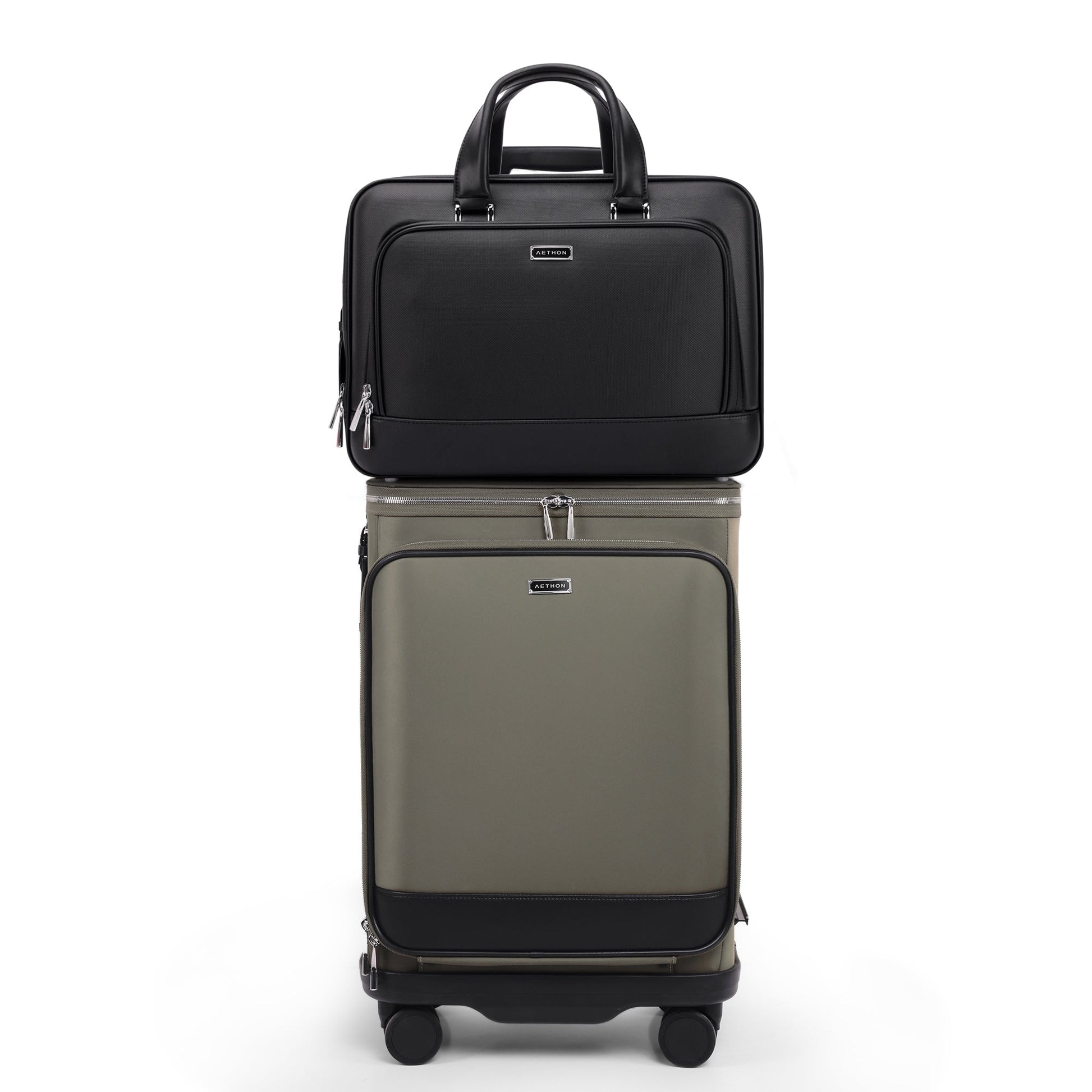 Stylera black leather business briefcase sitting atop olive carryon suitcase with front pockets and wheels for business travel