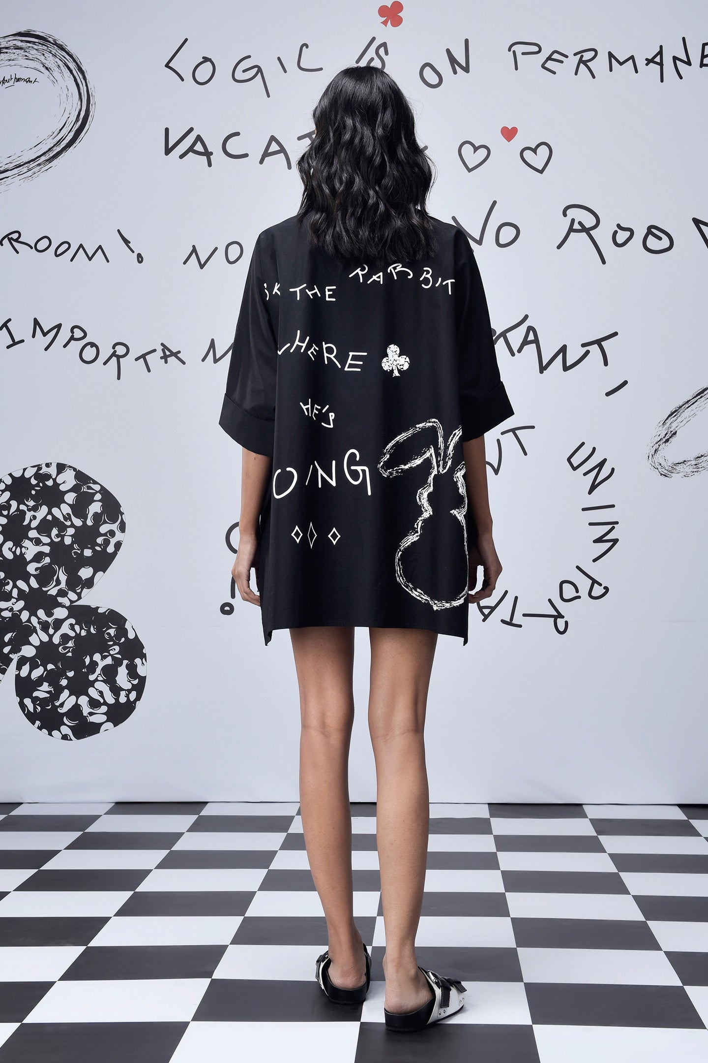 Back view of model wearing Stylera black scribble print shirt oversized boxy fit with white doodle motif