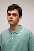 Stylera mint green polo T shirt on male model with three buttons and subtle shoulder print casual men&