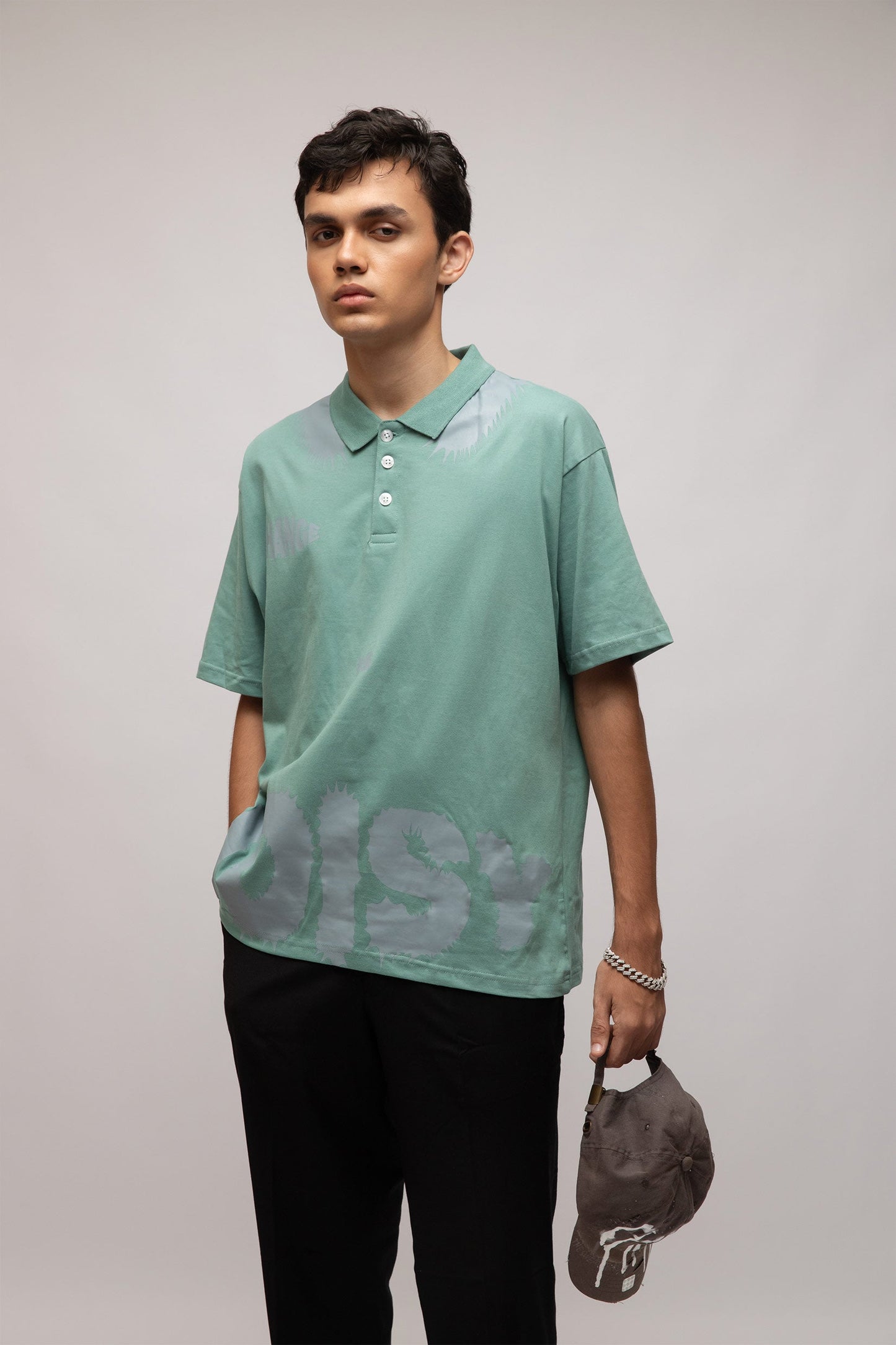 Stylera mint green short sleeve polo on male model holding gray cap casual men's fashion polo