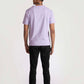 Back view of a man wearing a lavender t-shirt for men paired with black pants and white shoes