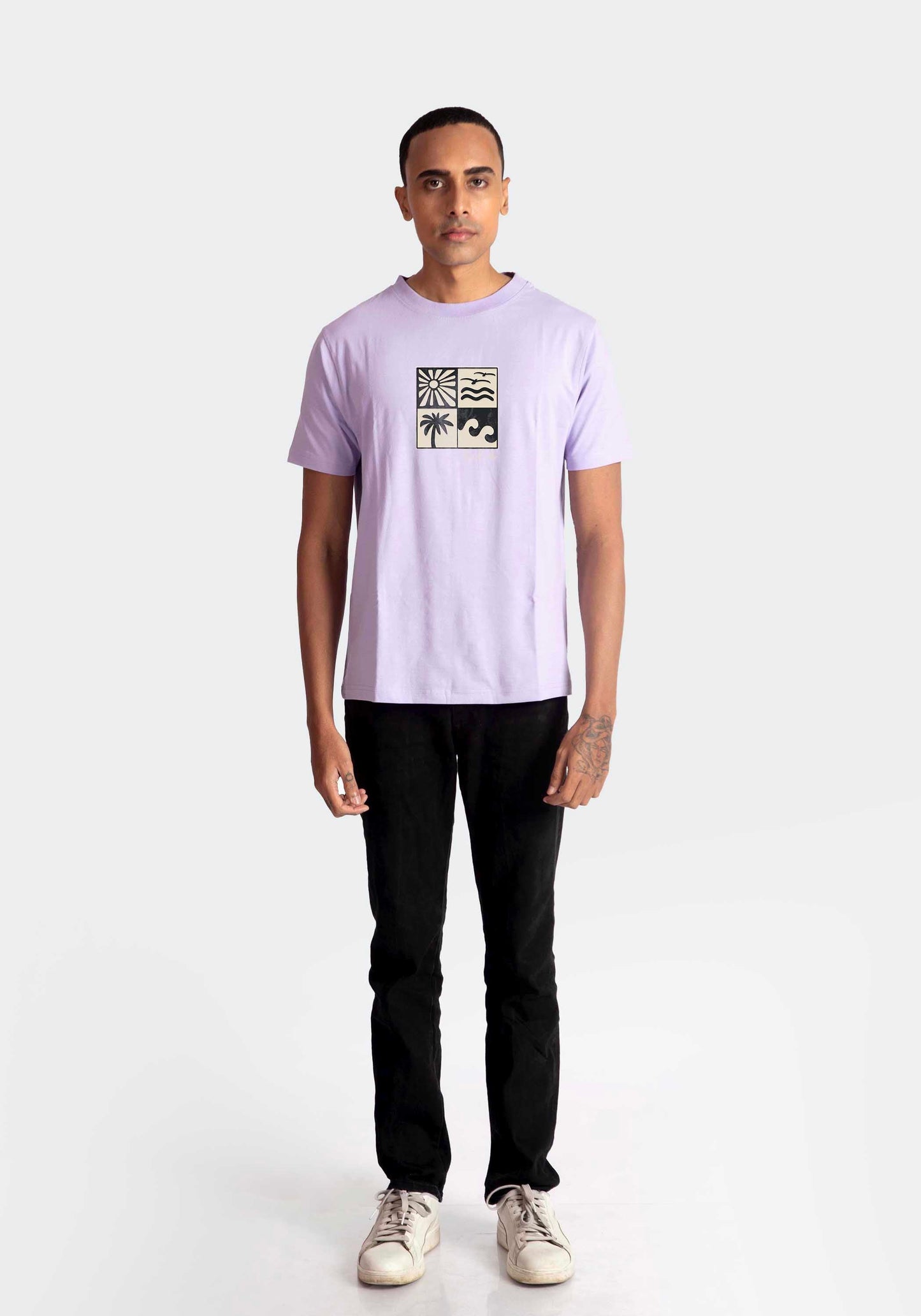 Stylera lavender t-shirt for men with graphic print paired with black pants and white sneakers