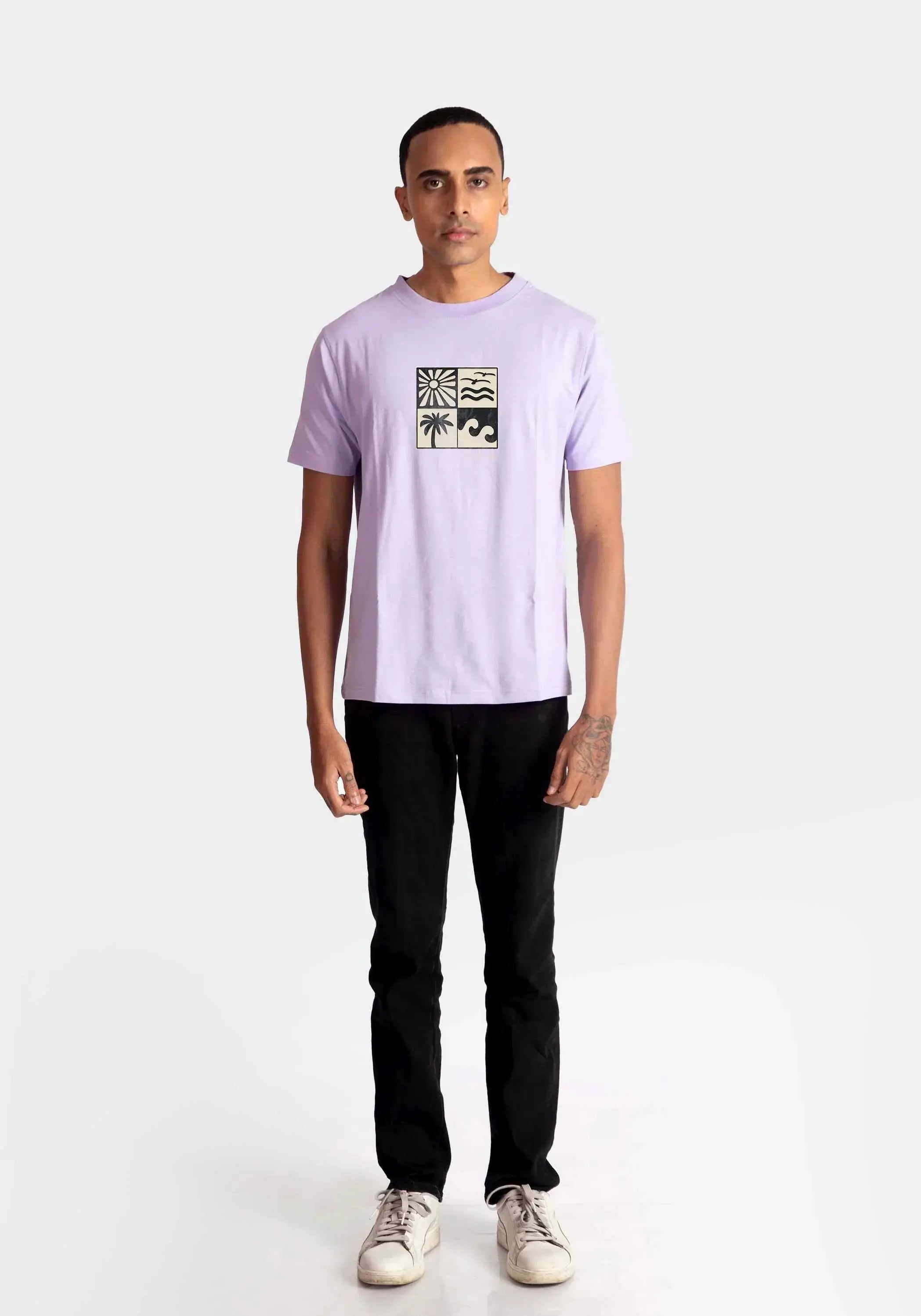 Stylera lavender t-shirt for men with graphic print paired with black pants and white sneakers