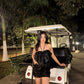 Model wearing Stylera Luna high waisted shorts black sequins with strapless top by golf cart at night