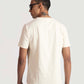 Back view of man wearing men's trendy cream t-shirt by Stylera paired with light blue jeans