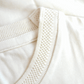 Close-up of Stylera men's trendy cream t-shirt collar with textured ribbed detail