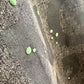 Stylera men's trendy graphic tee charcoal closeup with faded black lettering and neon green paint splatter dots