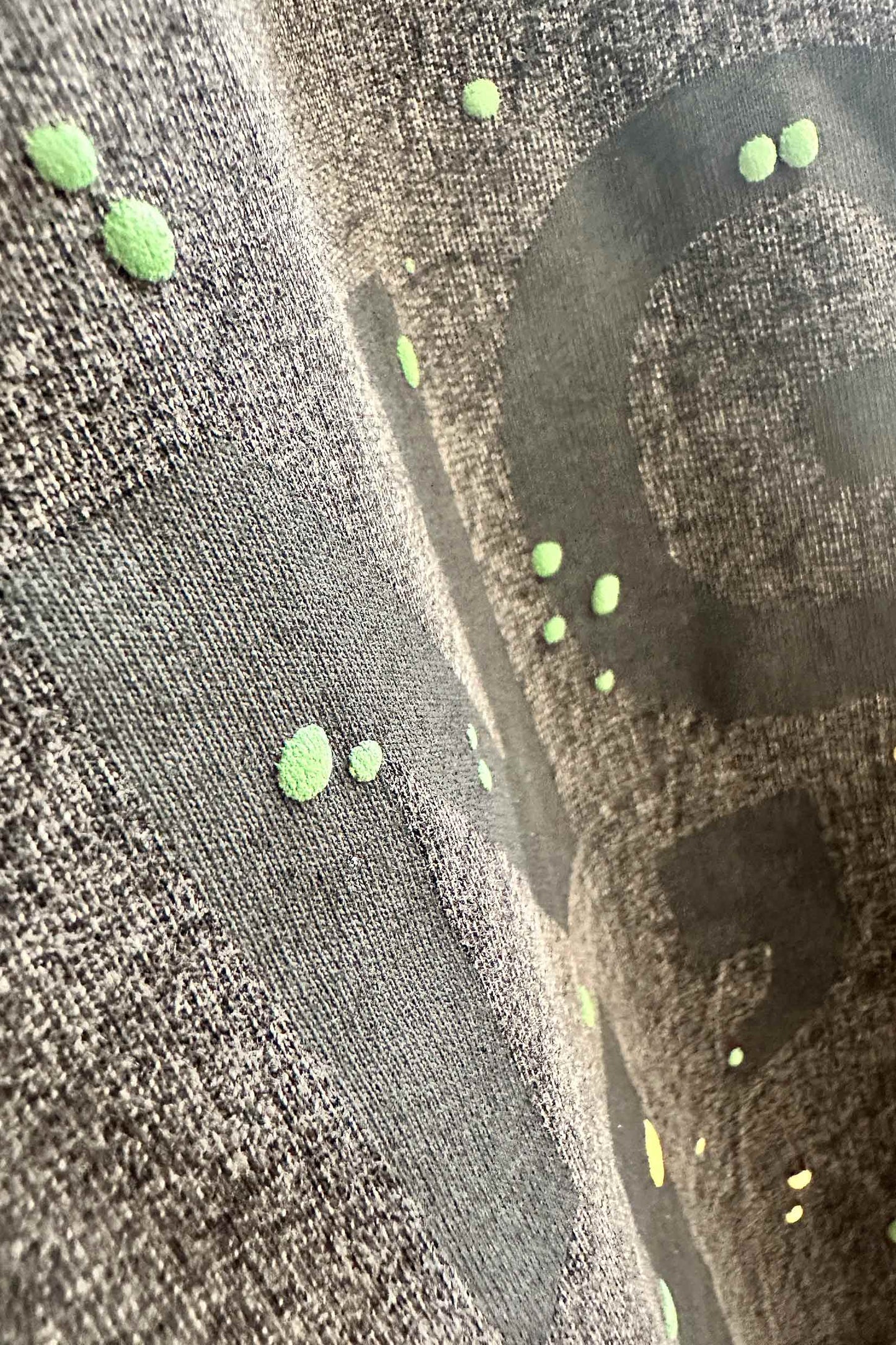 Stylera men's trendy graphic tee charcoal closeup with faded black lettering and neon green paint splatter dots