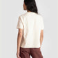 Back view of woman wearing motivational quote off white t-shirt for women paired with brown pants