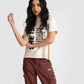 Motivational quote off white t-shirt for women worn by model with curly hair and brown cargo pants