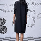 Back view of Stylera oversized black shirt dress trendy knee length with sequin sleeve detail and white sneakers