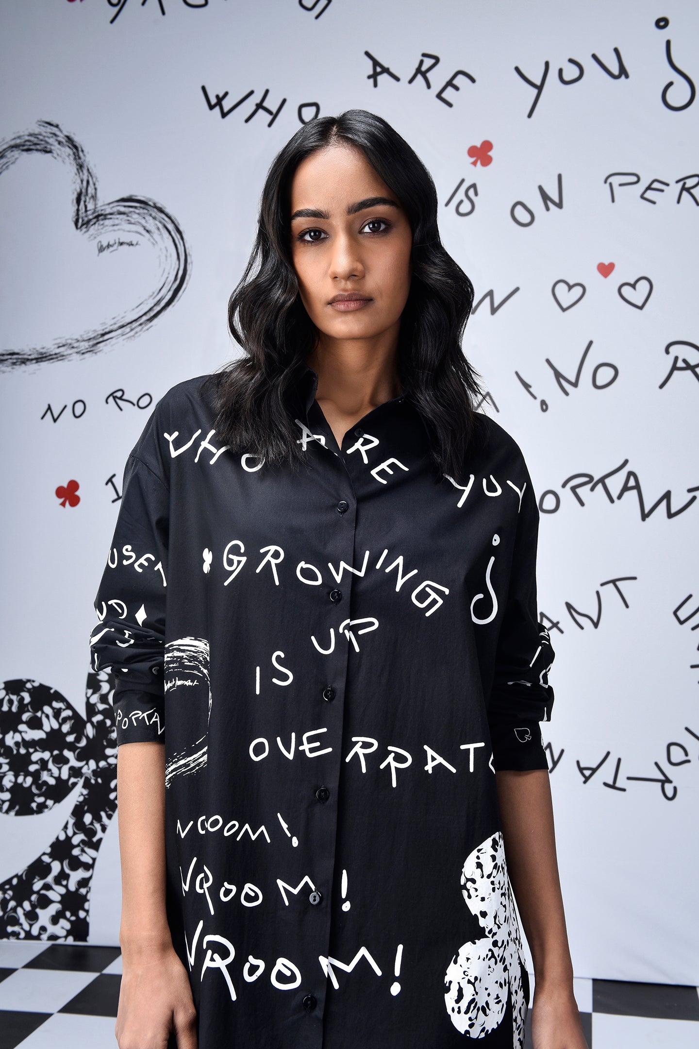 Stylera model wearing oversized black shirt dress trendy with white graffiti print and spread collar
