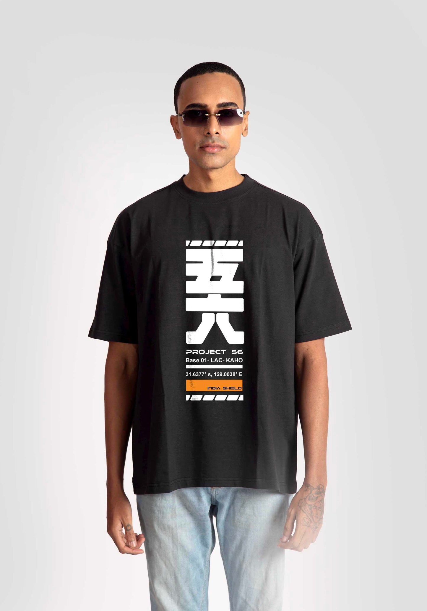 Stylera black oversized fashion t-shirt for men with white graphic print worn with light jeans