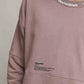 Stylera oversized sweatshirt for men in dusty rose with branded collar and chest print on model