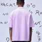 Back view of pink relaxed fit shirt for men by Stylera worn with black pants