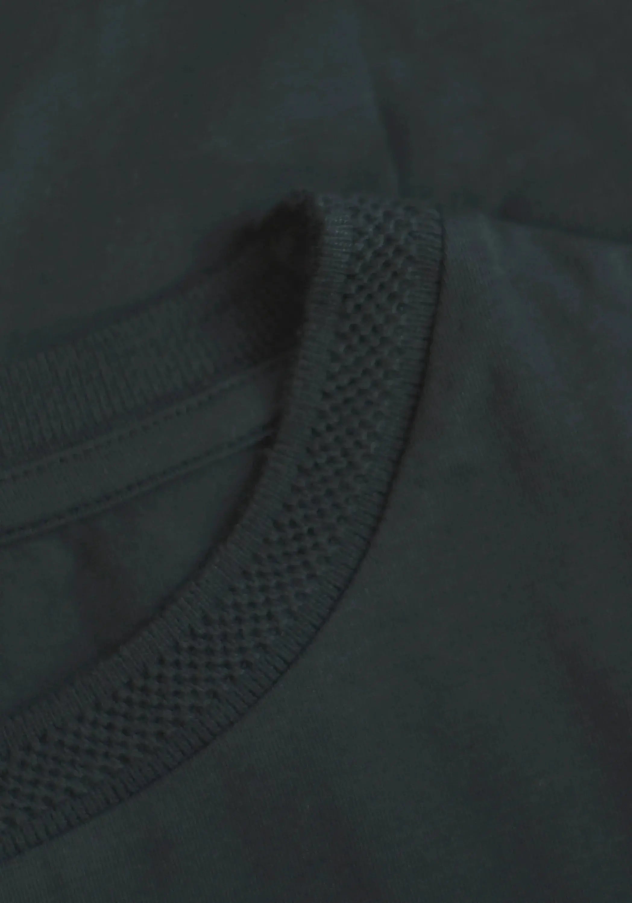 Close-up of Stylera regular fit black tee for men showing textured neckline and smooth fabric