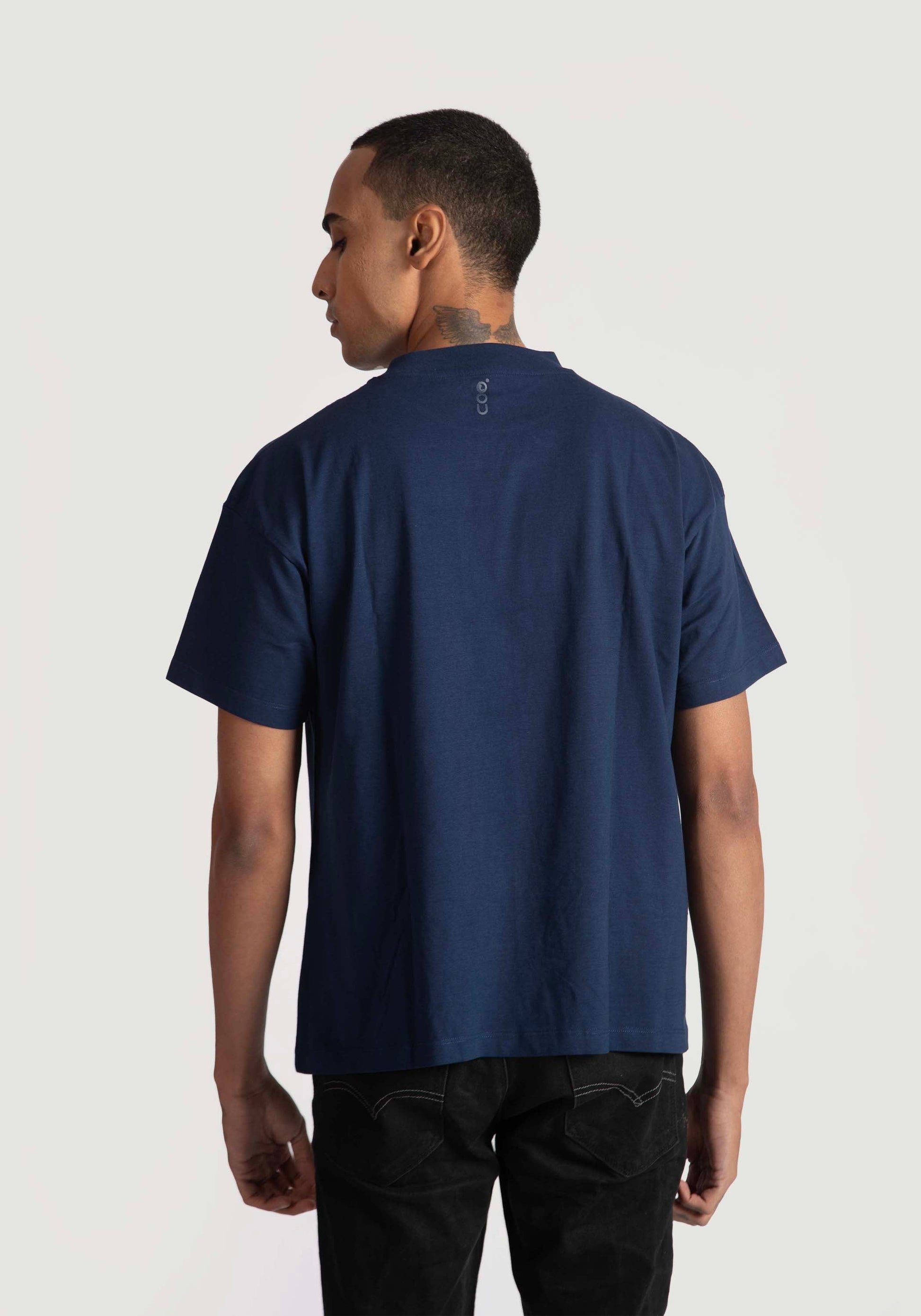 Back view of a man wearing navy blue regular fit men's fashion tee by Stylera