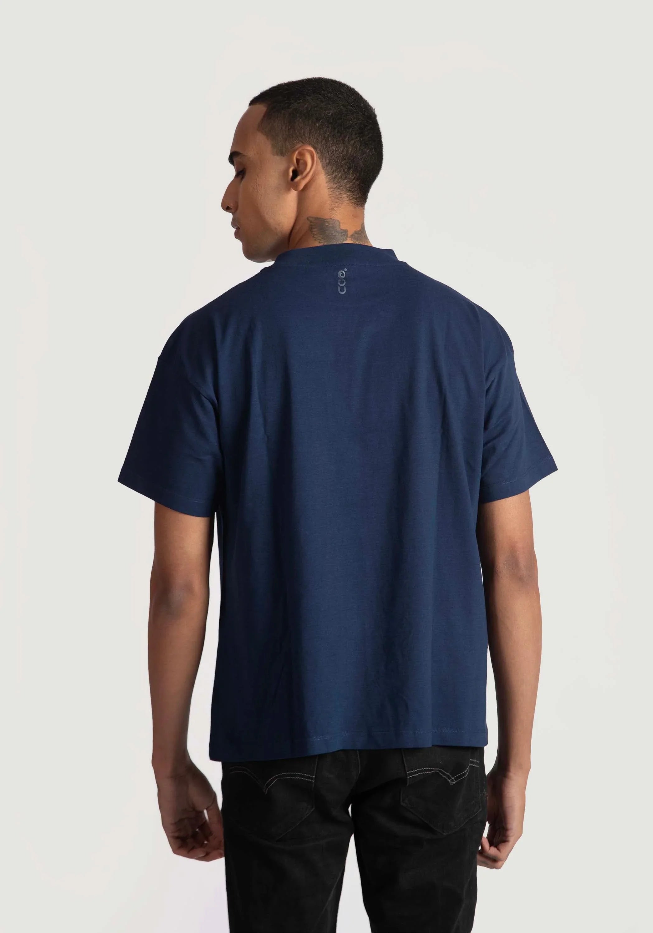 Back view of a man wearing navy blue regular fit men's fashion tee by Stylera