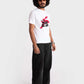 Stylera regular fit white tee with red and black graphic print worn by male model with black pants