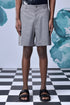 Stylera gray knee length shorts on model with black sandals relaxed fit shorts for everyday wear
