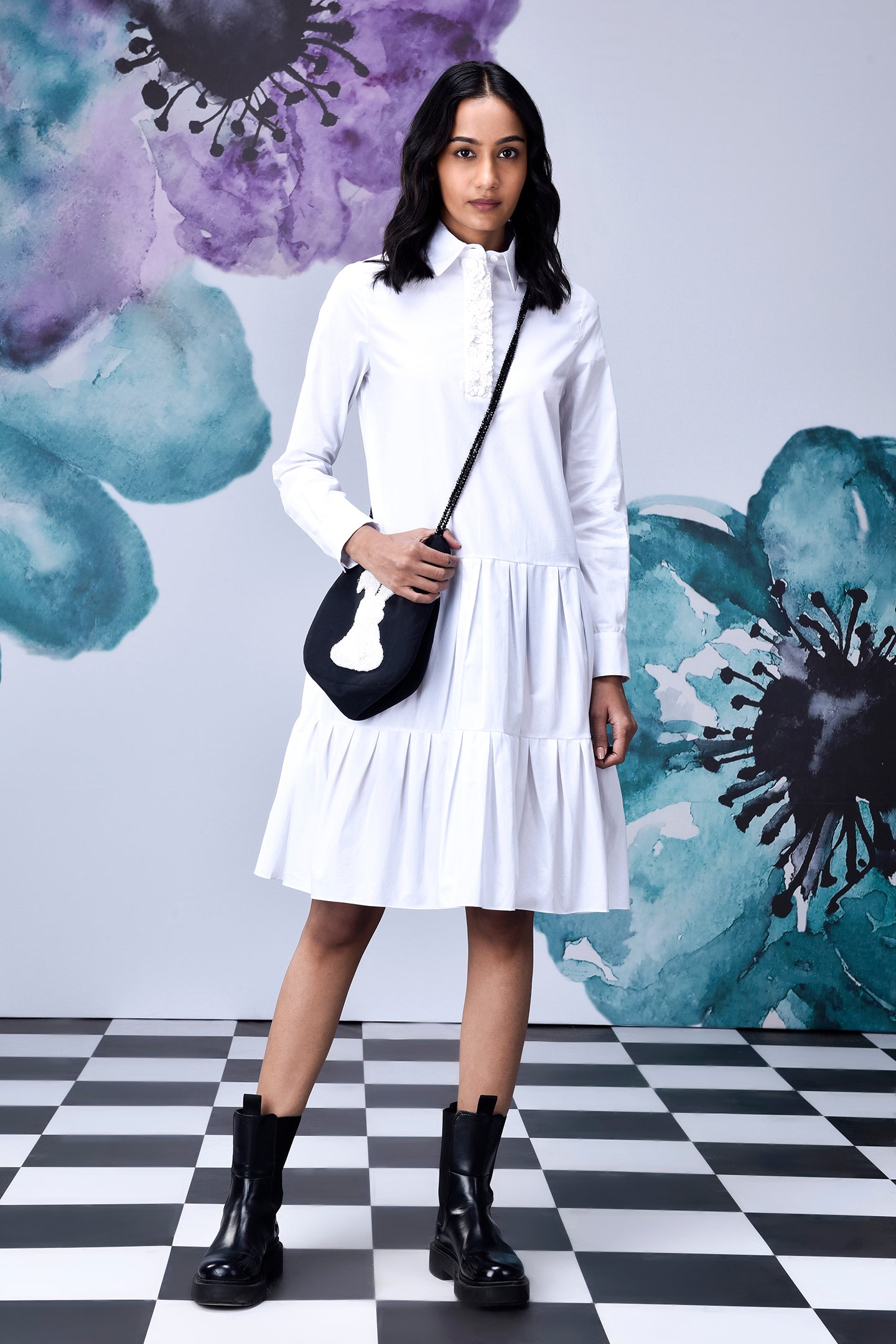 Model wearing relaxed fit white dress for women by Stylera with ruffle collar and tiered skirt
