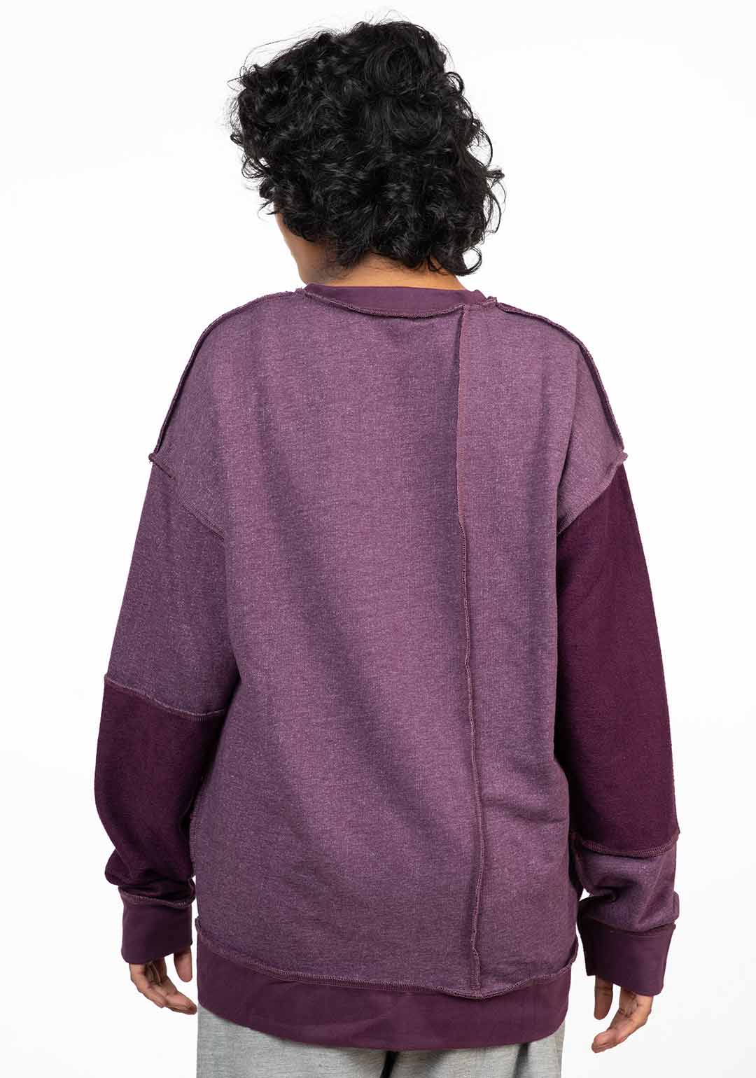 Stylera reversible oversized sweatshirt back view in two tone plum purple with dropped shoulders and relaxed fit