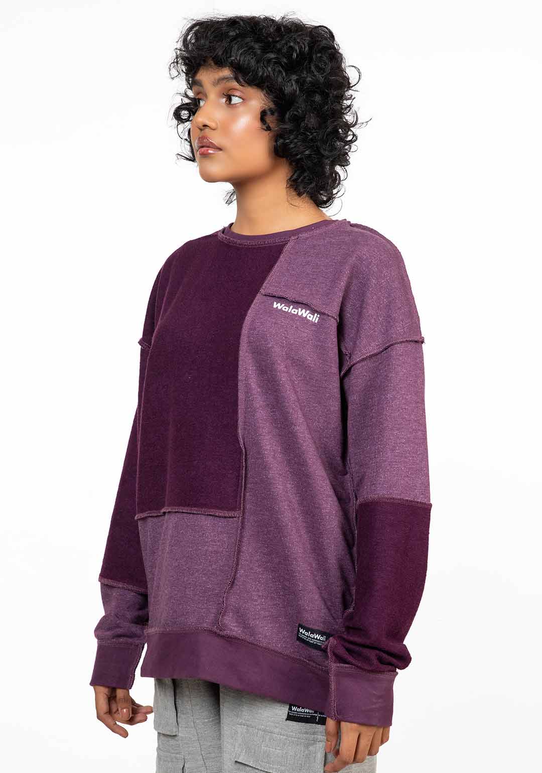 Stylera reversible oversized sweatshirt in patchwork plum tones on model with relaxed fit and cuffed sleeves