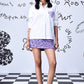 Stylera white sequin heart shirt women styled with purple floral skirt and matching sandals