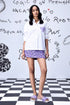Stylera white sequin heart shirt women styled with purple floral skirt and matching sandals