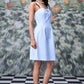 Slim fit casual dress with lace up front in light blue worn by model with black hair and pearl necklace
