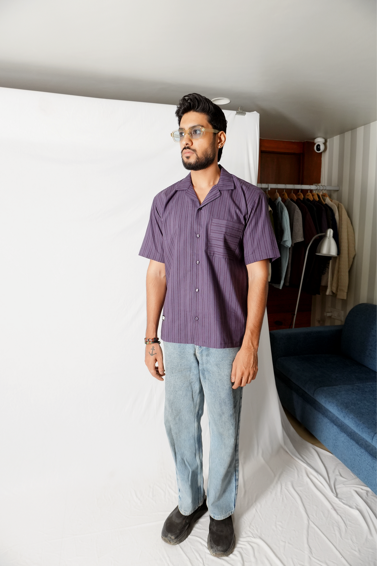 Stylera model wearing statement striped shirt purple short sleeve camp collar with light wash jeans