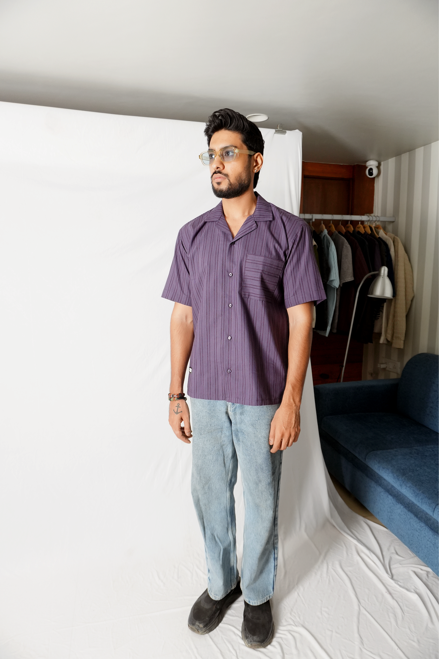 Stylera model wearing statement striped shirt purple short sleeve camp collar with light wash jeans