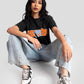 Trendy black oversized crop fit t-shirt by Stylera worn with light blue jeans and sneakers